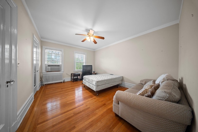 10-08 Shore Rd, Douglaston, NY 11363 - bedroom with radiator heating unit, light wood-style floors, baseboards, crown molding, and cooling unit