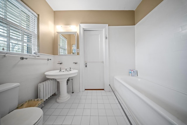 10-08 Shore Rd, Douglaston, NY 11363 - full bathroom with radiator, toilet, a tub to relax in, and tile patterned floors