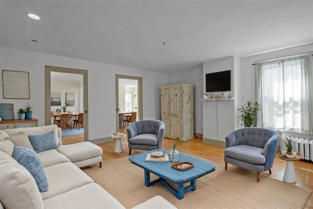 59 E Main St, Washingtonville, NY 10992 - living area featuring radiator heating unit, light wood-type flooring, and recessed lighting