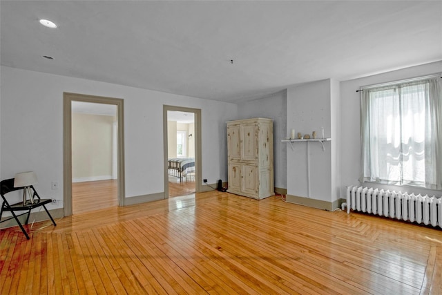 59 E Main St, Washingtonville, NY 10992 - unfurnished room featuring radiator heating unit, plenty of natural light, and hardwood / wood-style flooring