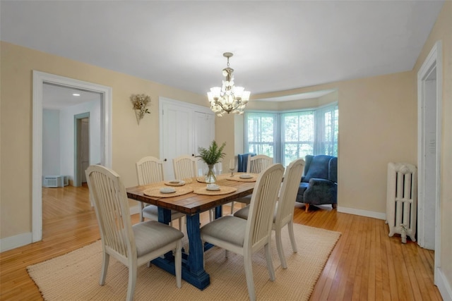 59 E Main St, Washingtonville, NY 10992 - dining room with radiator, a chandelier, baseboards, and light wood finished floors