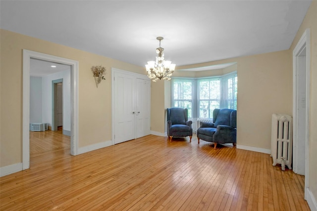 59 E Main St, Washingtonville, NY 10992 - sitting room with radiator heating unit, a chandelier, light wood-style floors, and baseboards