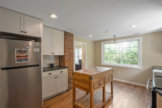 59 E Main St, Washingtonville, NY 10992 - kitchen featuring freestanding refrigerator, light wood-style floors, dark countertops, tasteful backsplash, and recessed lighting