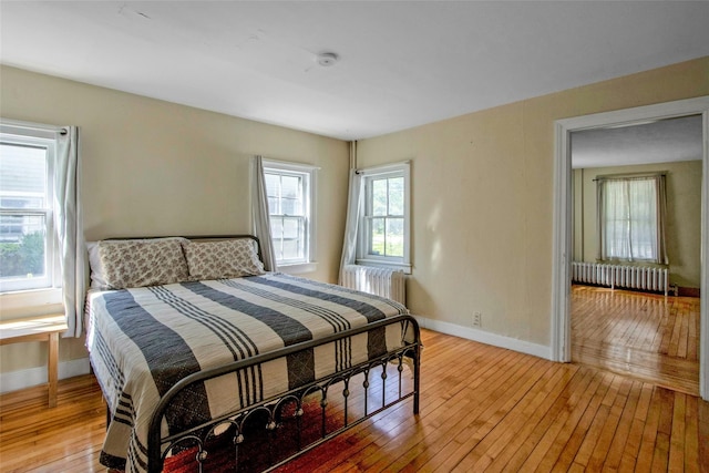 59 E Main St, Washingtonville, NY 10992 - bedroom with radiator heating unit, light wood-style floors, and baseboards