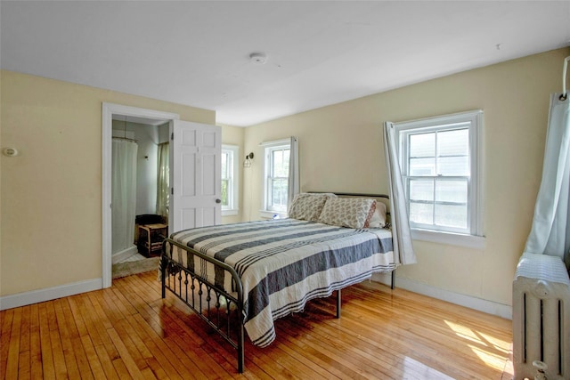 59 E Main St, Washingtonville, NY 10992 - bedroom featuring radiator heating unit, light wood-style flooring, and baseboards