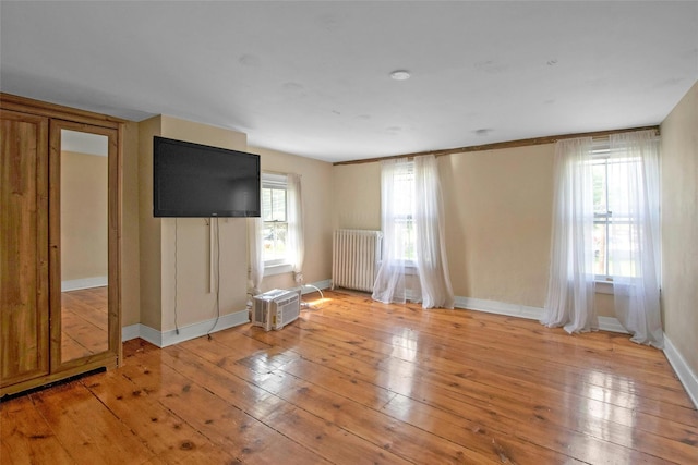 59 E Main St, Washingtonville, NY 10992 - unfurnished living room featuring radiator, light wood finished floors, and baseboards