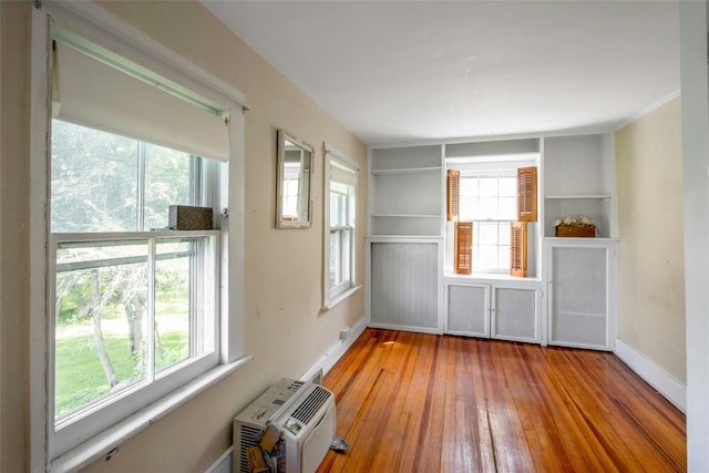 59 E Main St, Washingtonville, NY 10992 - unfurnished room with hardwood / wood-style flooring, an AC wall unit, and baseboards