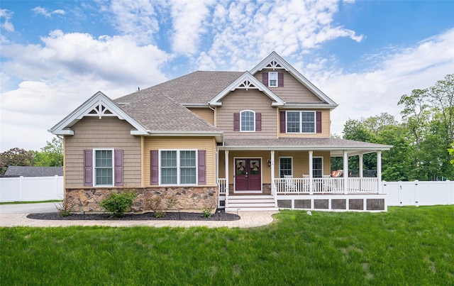 craftsman inspired home with stone siding, a porch, and a shingled roof