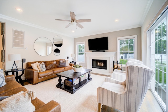 living room with a ceiling fan, wood finished floors, crown molding, a fireplace with flush hearth, and recessed lighting