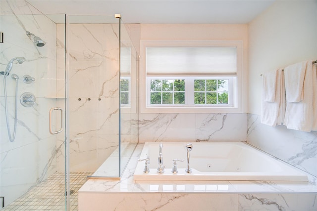 full bathroom with a marble finish shower and a whirlpool tub