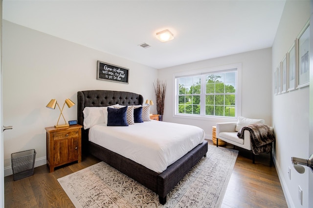 bedroom with wood finished floors and baseboards
