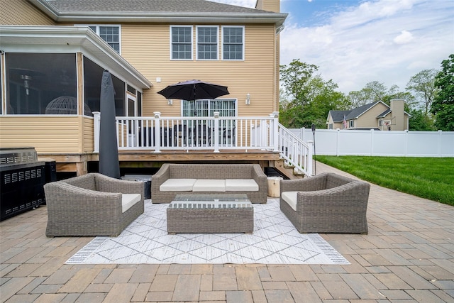 view of patio featuring a sunroom, fence, an outdoor living space, and a deck