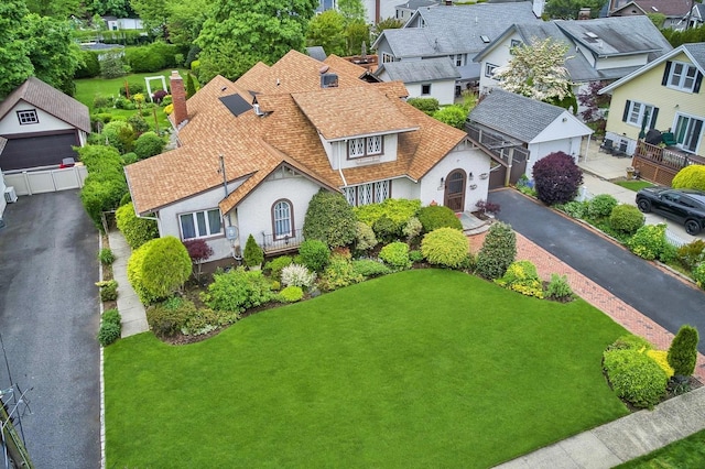 2600 Garden St, Baldwin, NY 11510 - view of front facade with a residential view, roof with shingles, a chimney, and a front lawn