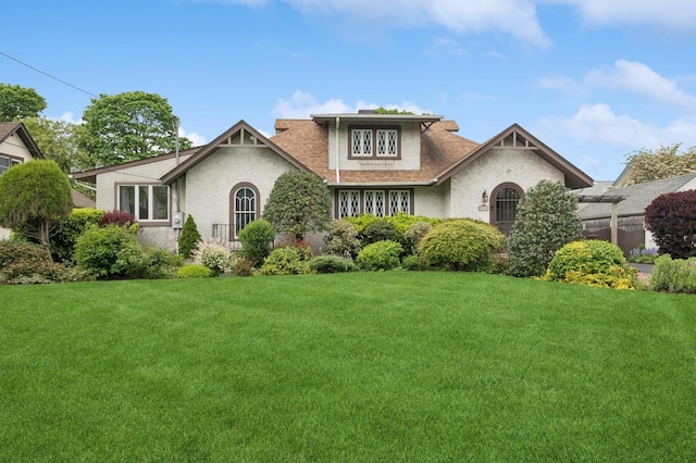 2600 Garden St, Baldwin, NY 11510 - english style home with a front lawn, stucco siding, and roof with shingles