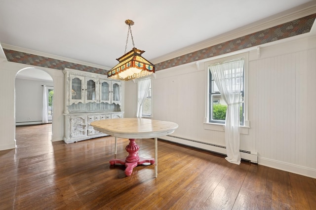 2600 Garden St, Baldwin, NY 11510 - unfurnished dining area featuring healthy amount of natural light, a baseboard heating unit, arched walkways, hardwood / wood-style flooring, and crown molding