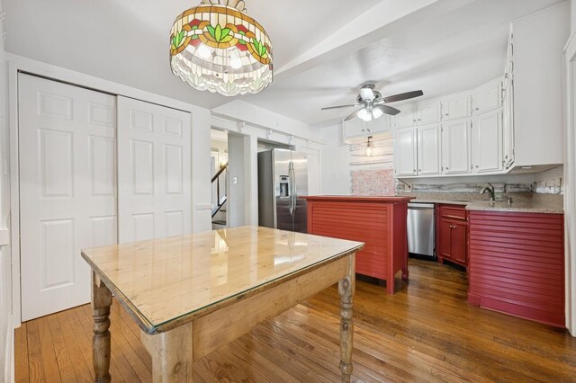 2600 Garden St, Baldwin, NY 11510 - kitchen with stainless steel appliances, dark wood-style floors, ceiling fan, light countertops, and white cabinetry