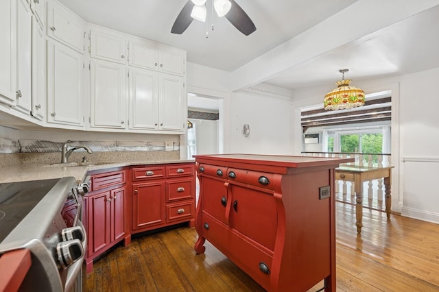 2600 Garden St, Baldwin, NY 11510 - kitchen with stainless steel range with electric stovetop, hardwood / wood-style floors, ceiling fan, and light countertops