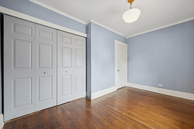 2600 Garden St, Baldwin, NY 11510 - unfurnished bedroom featuring baseboards, dark wood-style floors, ornamental molding, and a closet