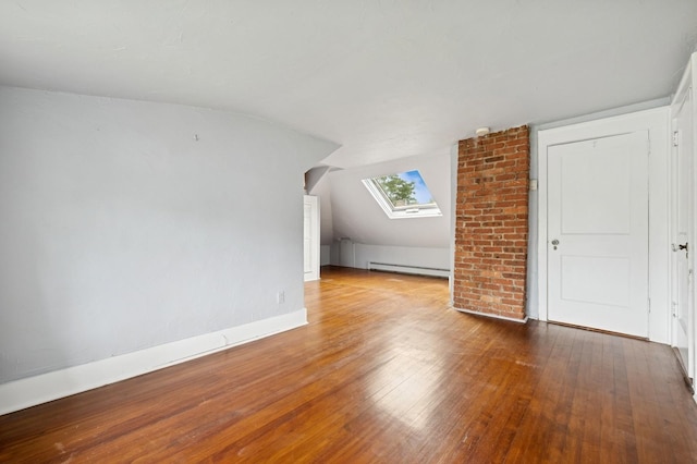 2600 Garden St, Baldwin, NY 11510 - bonus room featuring wood finished floors, a baseboard heating unit, a skylight, lofted ceiling, and baseboards