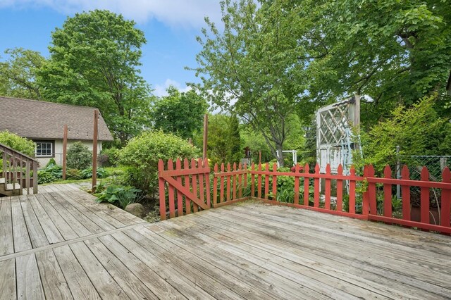 2600 Garden St, Baldwin, NY 11510 - wooden deck featuring fence and view of wooded area