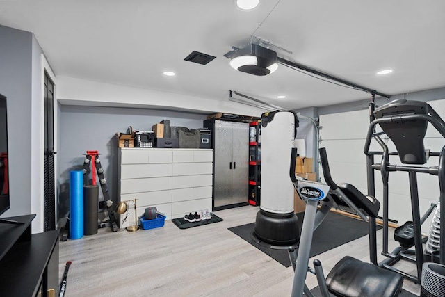181 Central Park Rd E, Plainview, NY 11803 - workout room with wood finished floors, recessed lighting, and a garage