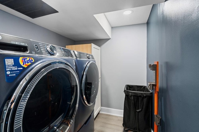 181 Central Park Rd E, Plainview, NY 11803 - laundry room with washing machine and clothes dryer, cabinet space, wood finished floors, and baseboards