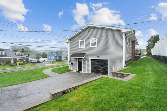181 Central Park Rd E, Plainview, NY 11803 - view of home's exterior with central AC unit, driveway, a residential view, and a garage