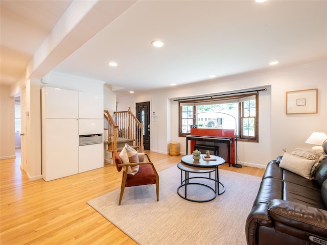 94 Shadyside Ave, Port Washington, NY 11050 - living room featuring stairway, light wood finished floors, recessed lighting, and crown molding