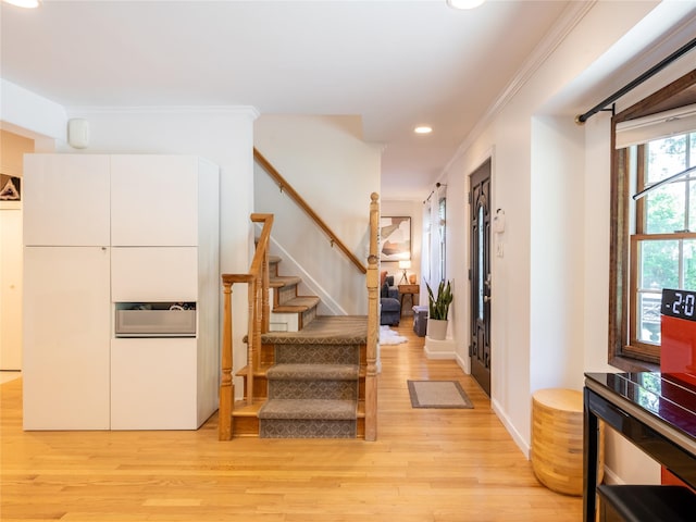 94 Shadyside Ave, Port Washington, NY 11050 - entryway with light wood-type flooring, recessed lighting, stairs, crown molding, and baseboards