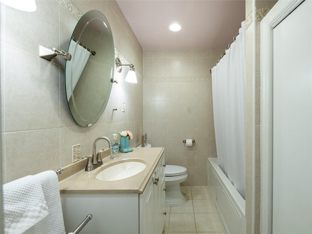 94 Shadyside Ave, Port Washington, NY 11050 - bathroom featuring tile patterned flooring, tile walls, vanity, toilet, and shower / bath combo