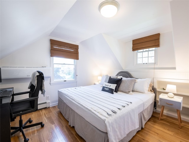 94 Shadyside Ave, Port Washington, NY 11050 - bedroom featuring light wood-style floors, vaulted ceiling, and a baseboard radiator