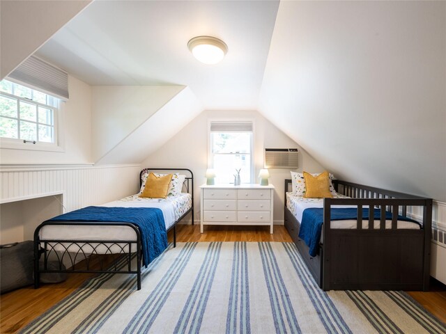 94 Shadyside Ave, Port Washington, NY 11050 - bedroom with multiple windows, wood finished floors, lofted ceiling, and wainscoting