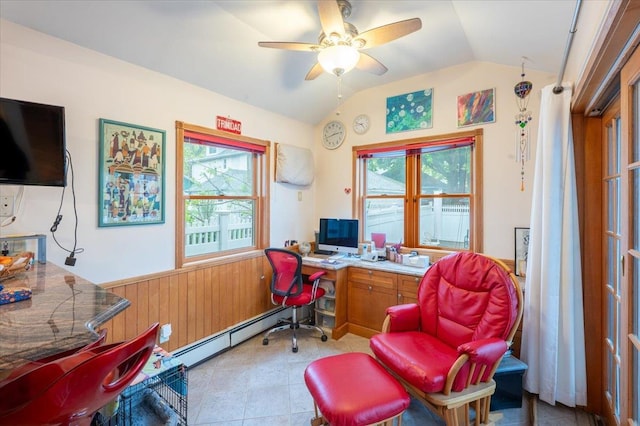 office area with vaulted ceiling, a wainscoted wall, wood walls, a ceiling fan, and baseboard heating