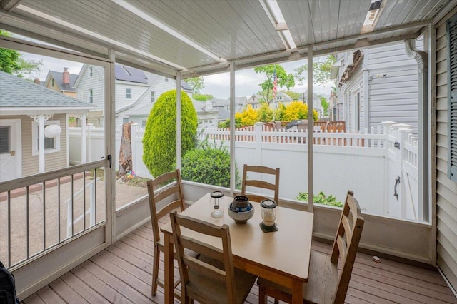 sunroom / solarium with healthy amount of natural light and a residential view