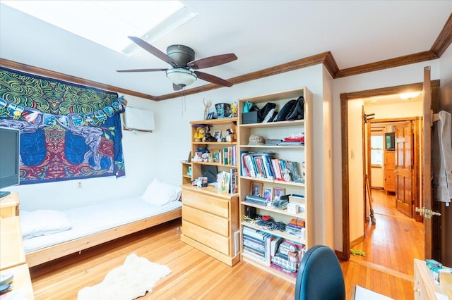 bedroom featuring light wood-type flooring, ornamental molding, an AC wall unit, and ceiling fan