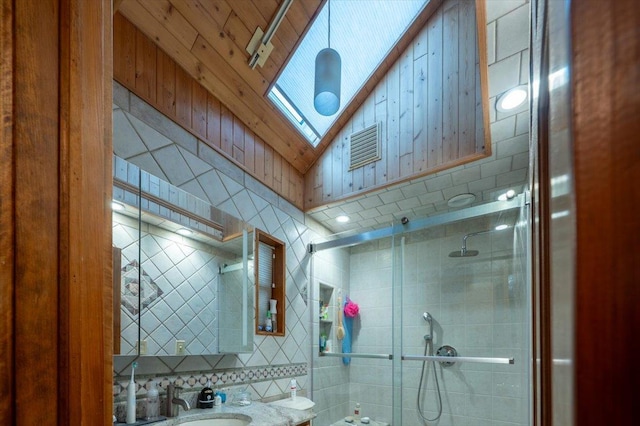 full bath with tiled shower, tile walls, vanity, and tasteful backsplash