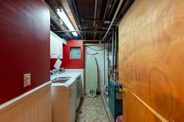 clothes washing area featuring electric panel, cabinet space, separate washer and dryer, and light flooring