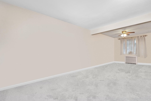 carpeted empty room featuring baseboards and ceiling fan