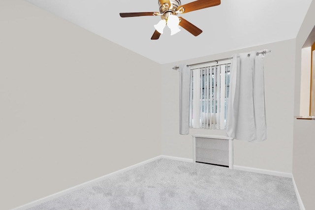 carpeted spare room featuring baseboards, ceiling fan, and lofted ceiling