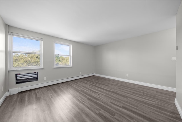 280 Lowndes Ave Unit 305G, Huntington Station, NY 11746 - spare room with a baseboard radiator, dark wood-style floors, and baseboards