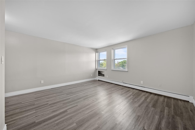280 Lowndes Ave Unit 305G, Huntington Station, NY 11746 - unfurnished room with wood finished floors, baseboards, and a baseboard radiator