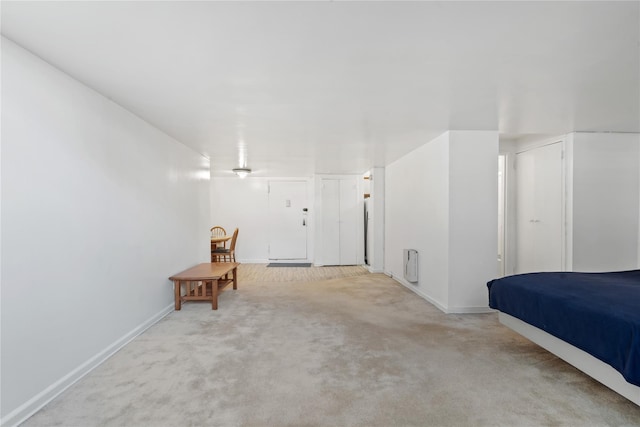 110-20 71st Ave Unit 106, Forest Hills, NY 11375 - unfurnished bedroom featuring carpet, baseboards, heating unit, and two closets
