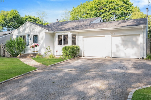 105 1st Ave, Kings Park, NY 11754 - view of front facade featuring asphalt driveway, a garage, and a front lawn