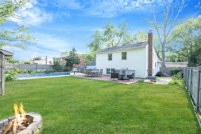 105 1st Ave, Kings Park, NY 11754 - back of house with an outdoor fire pit, a fenced backyard, a chimney, and a patio area