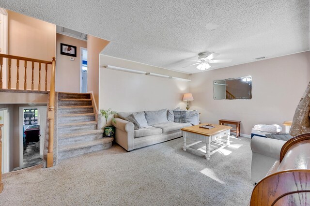 105 1st Ave, Kings Park, NY 11754 - carpeted living room with stairway, a ceiling fan, and a textured ceiling