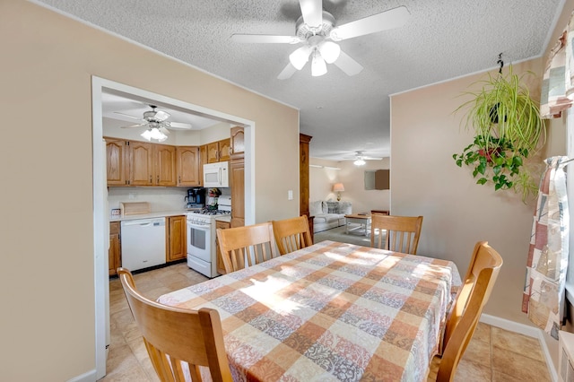 105 1st Ave, Kings Park, NY 11754 - dining area featuring a ceiling fan, a textured ceiling, and light tile patterned flooring