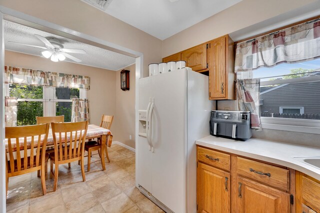 105 1st Ave, Kings Park, NY 11754 - kitchen with white fridge with ice dispenser, plenty of natural light, light countertops, and ceiling fan