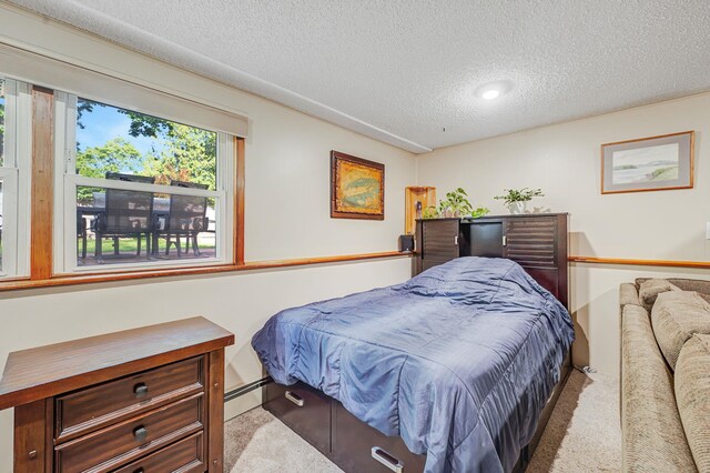 105 1st Ave, Kings Park, NY 11754 - carpeted bedroom featuring a textured ceiling, a baseboard radiator, and recessed lighting