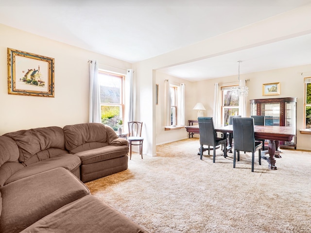 2182 Old Rte 17, Roscoe, NY 12776 - carpeted living room featuring plenty of natural light, a chandelier, and baseboards