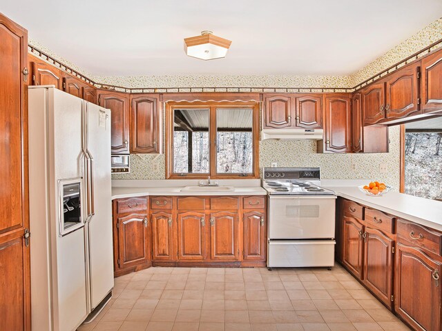 2182 Old Rte 17, Roscoe, NY 12776 - kitchen featuring white appliances, under cabinet range hood, wallpapered walls, light countertops, and a sink